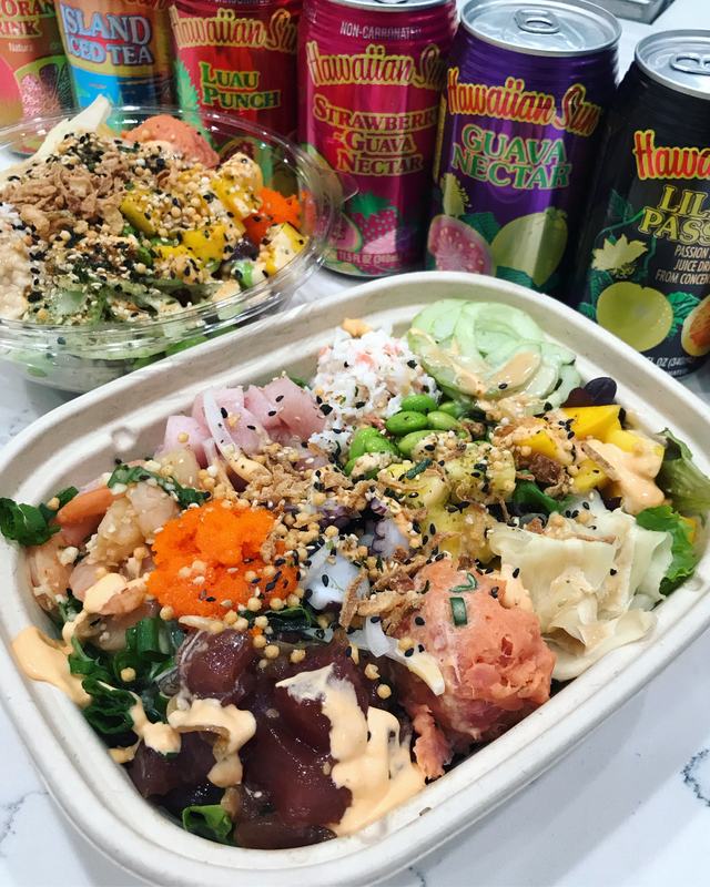 Poke bowl in a takeout tray with tuna, salmon, masago and spicy mayo, Hawaiian Sun cans behind