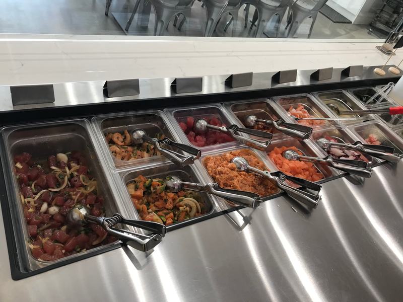 The protein counter: trays of poke, each with its own scoop